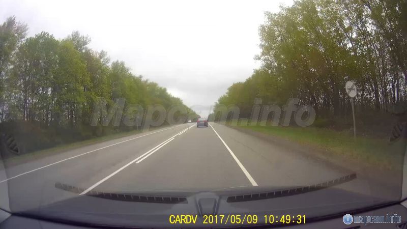 Сама машина стоит в самом конце холма после знака 