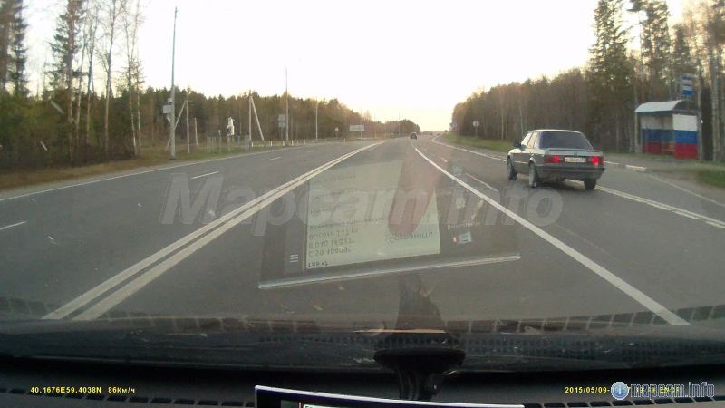 Слева, если ехать в Москву, напротив остановки